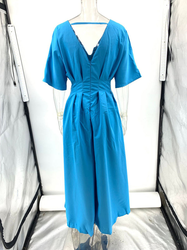 Back view of a blue dolman sleeve midi dress on a mannequin, showcasing the V-neckline, cinched waist, and pleated skirt.