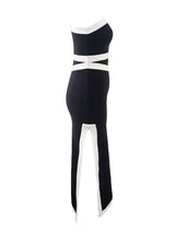 back view of a black and white one-shoulder midi dress with contrast trim