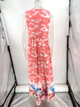 Back view of a pink sleeveless maxi dress with a cloud print.