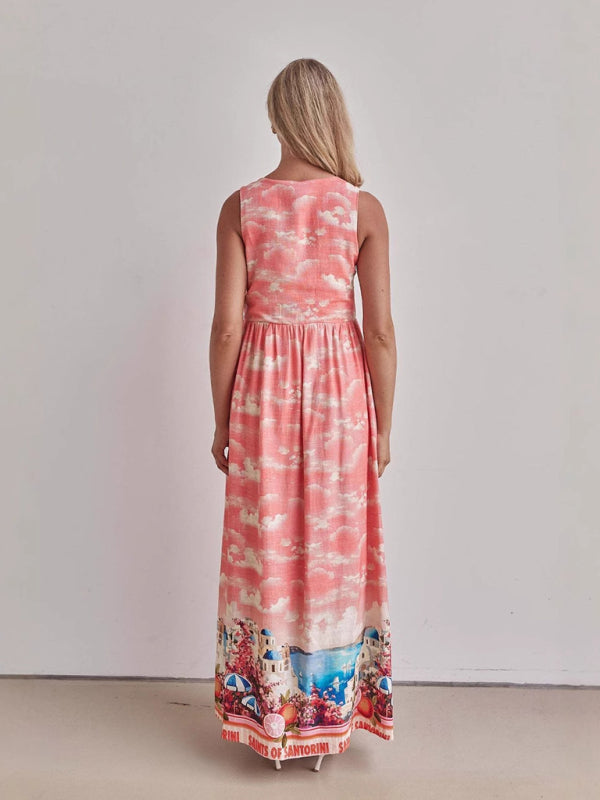 Back view of a woman wearing a pink sleeveless maxi dress with a cloud print.