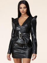 Close-up of a black faux leather V-neck dress with shoulder pads and a belted waist