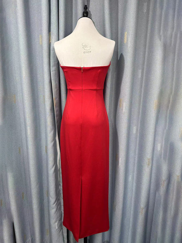 Back view of a red strapless midi dress with a zipper closure and a slit.