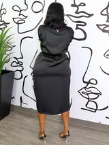 back view of a woman in a black satin dress