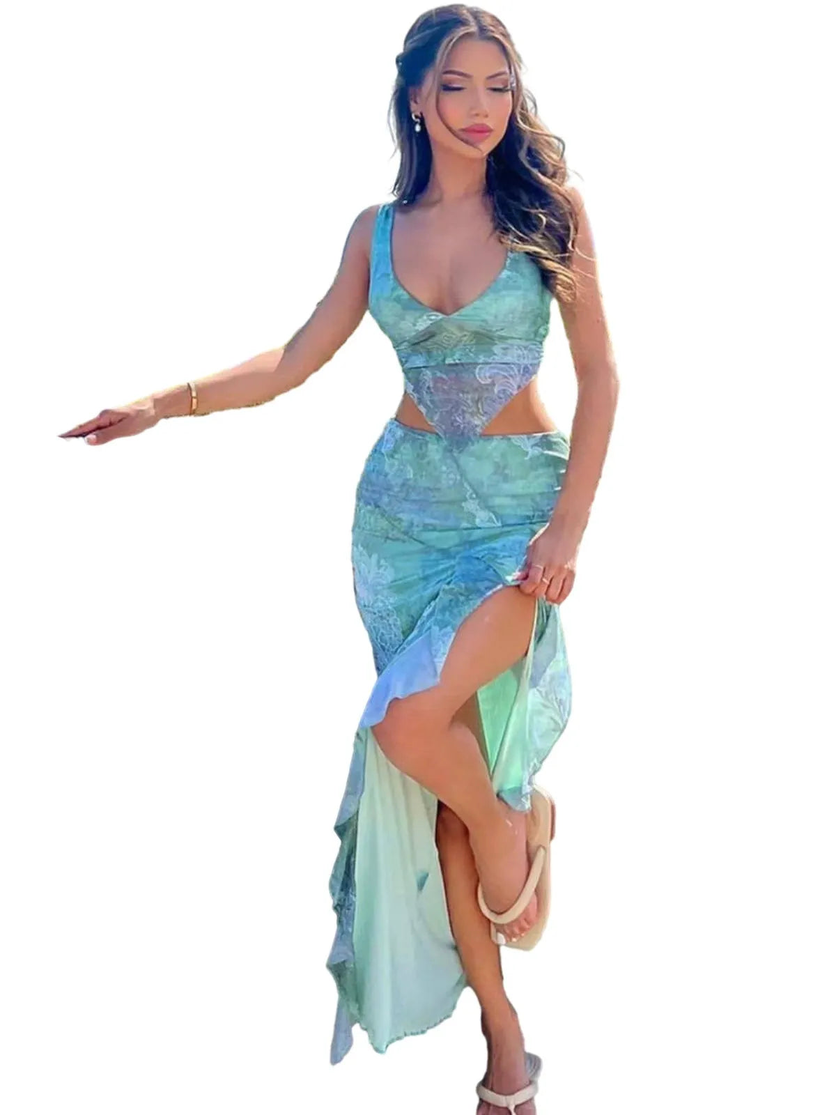 Full-body shot of a woman in a green floral print maxi dress with cut-out detail and high slit, isolated on a white background.