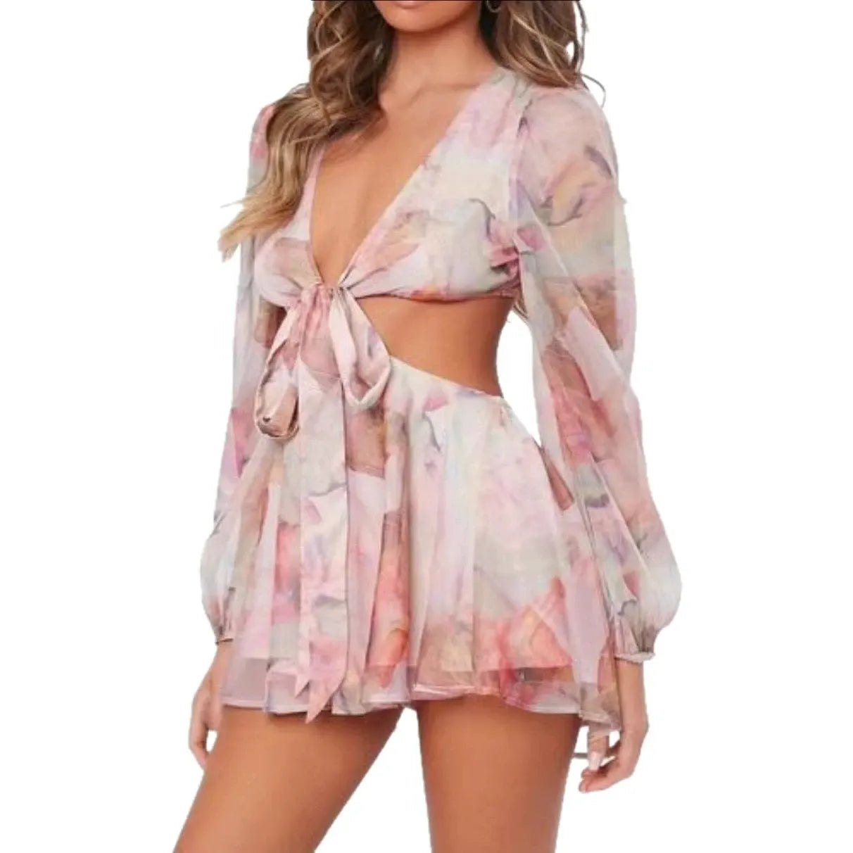 Woman wearing a light pink and floral print two-piece set with a deep V-neck, front tie, and cut-out detail.