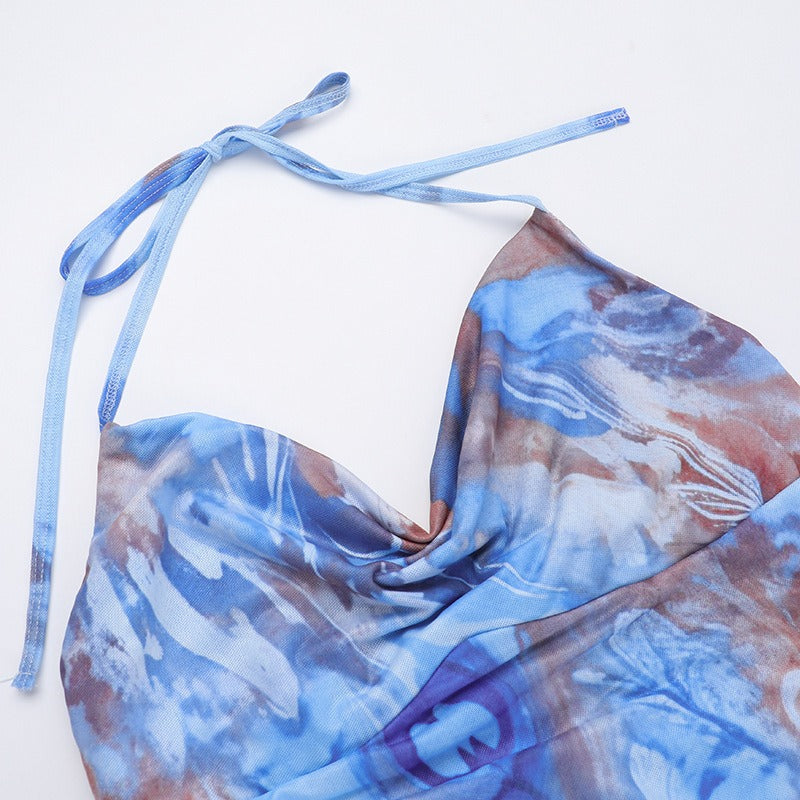 Close-up of the halter neckline and tie closure on a blue abstract print dress