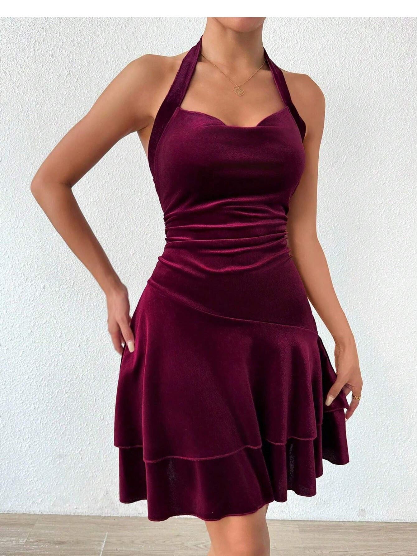 Close-up of a maroon velvet halter dress with a layered skirt