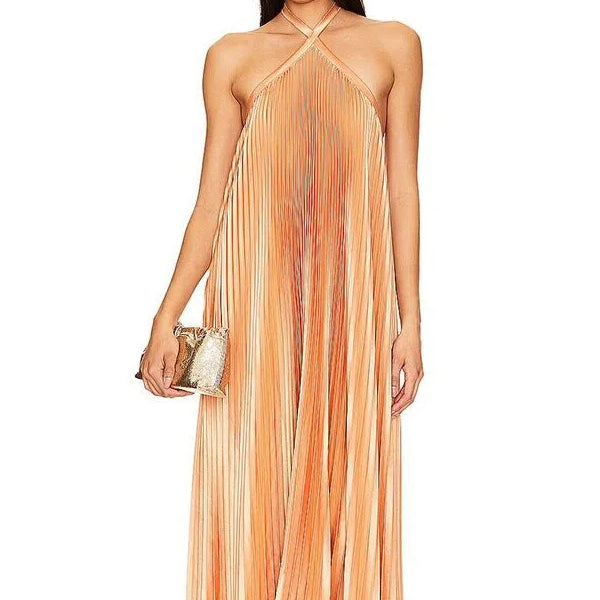 woman in peach pleated halter maxi dress with gold clutch, close up