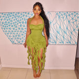 Woman wearing a lime green halter dress with ruffled trim and a fringed hem