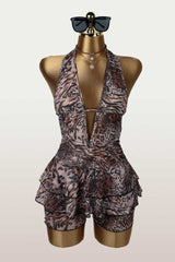 Leopard print halter romper displayed on a mannequin with sunglasses and a necklace.
