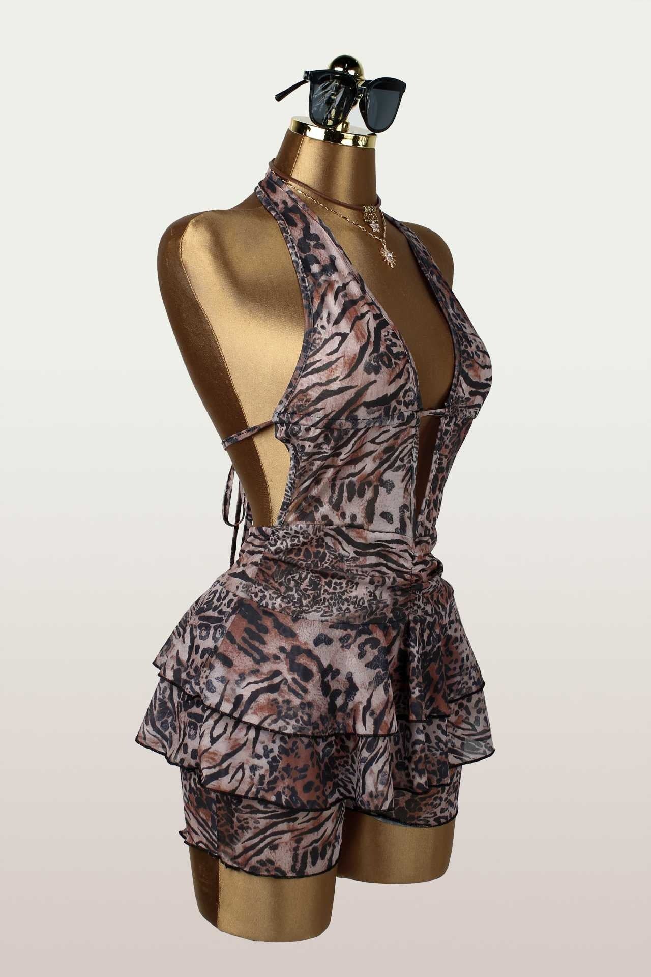 Side view of a leopard print halter romper on a mannequin, showcasing the silhouette.