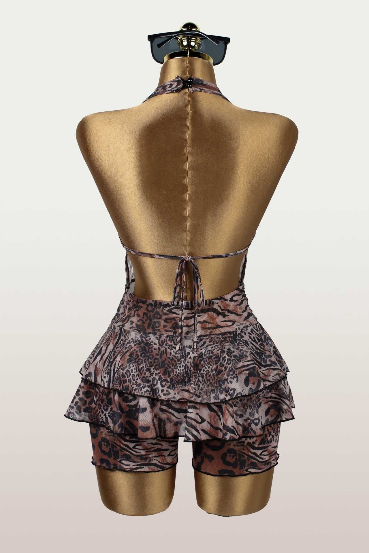 Back view of a leopard print halter romper on a mannequin, revealing the tie-back closure.