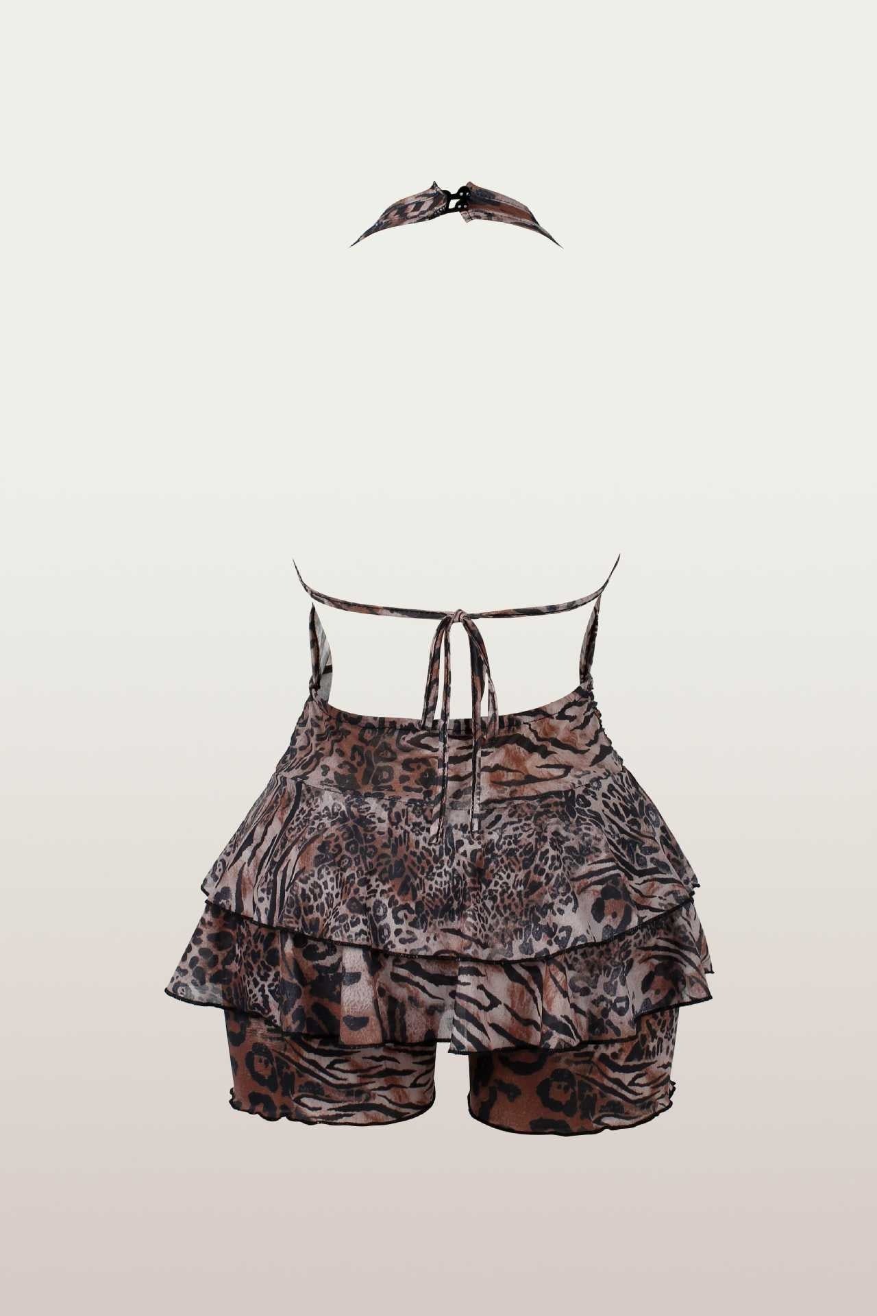 Back view of a leopard print halter romper with a tiered ruffled skirt and tie-back straps.