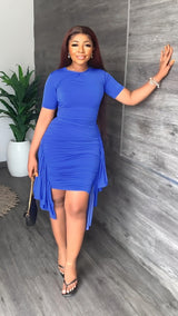 woman in royal blue ruched dress with asymmetrical hem