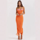 woman wearing a long orange ribbed knit dress with lace trim and sheer hem