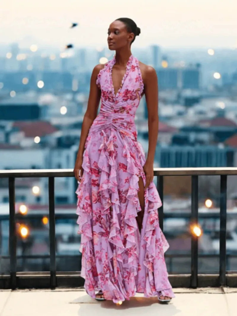 Woman in a lavender floral print ruffled gown with a halter neckline.