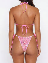 Back view of a pink sequined bikini with pearl accents