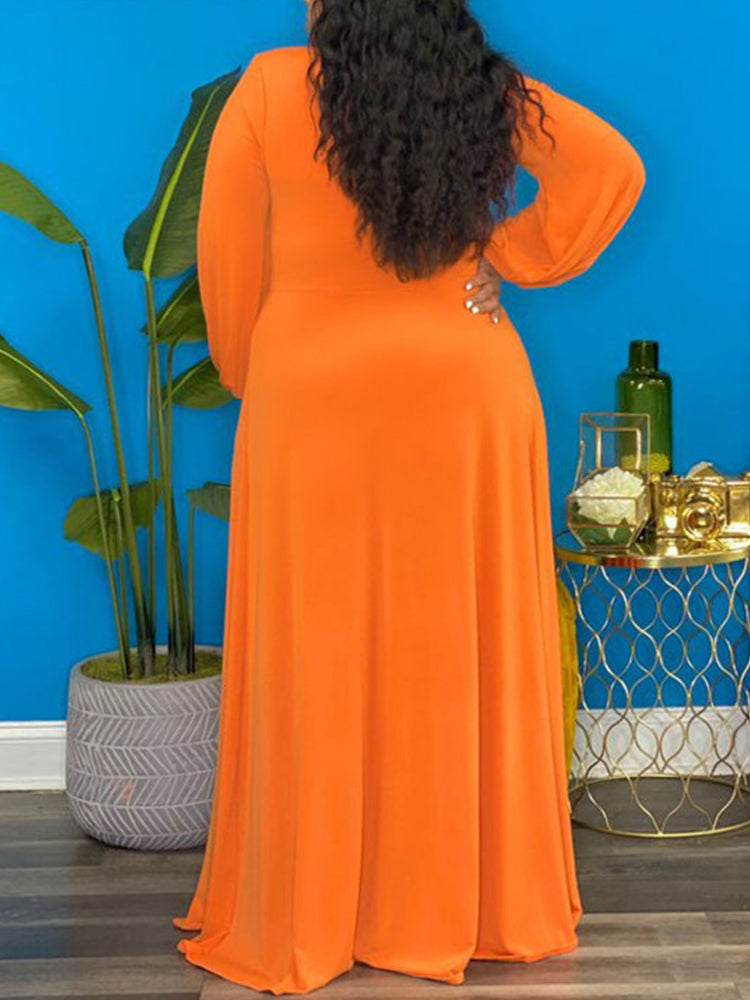 Back view of a woman wearing an orange maxi dress.
