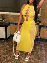 Woman wearing a yellow sleeveless bodycon dress with mesh side panels and cut-out neckline, holding a white handbag.
