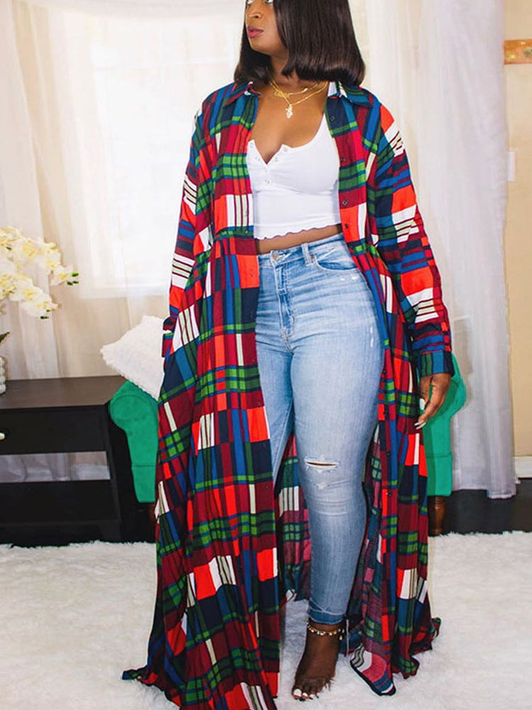 Woman wearing a long plaid maxi dress with a white crop top and light wash jeans