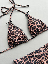 Close-up of the leopard print triangle bikini top with lace trim.