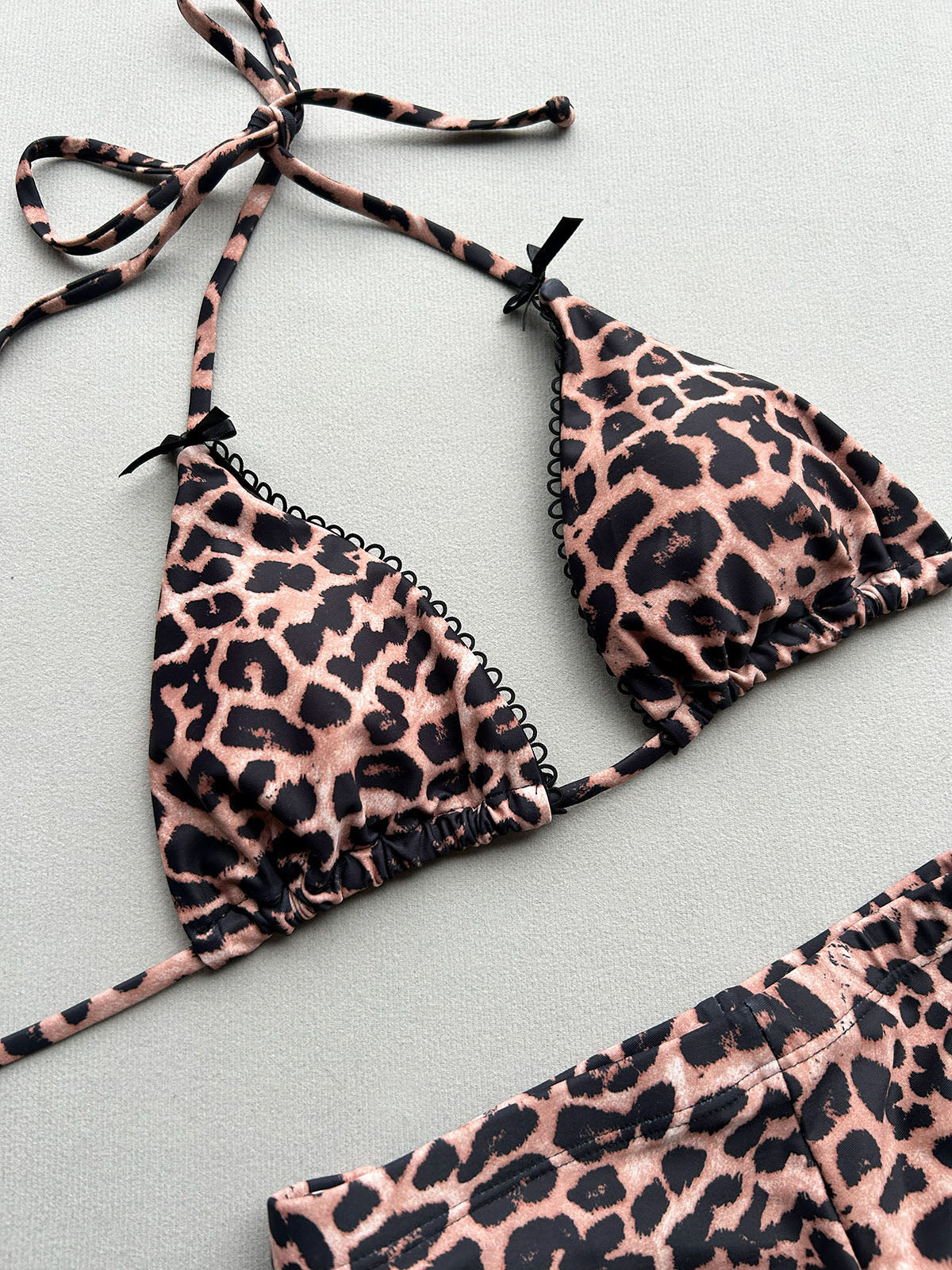 Close-up of the leopard print triangle bikini top with lace trim.