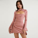 Model wearing a rose gold satin mini dress with a cut-out neckline and flared sleeves