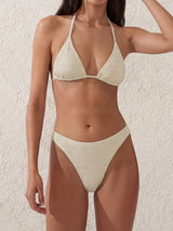 Woman wearing a cream crinkle knit triangle bikini