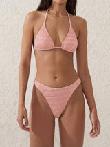 Woman wearing a pink crinkle knit triangle bikini