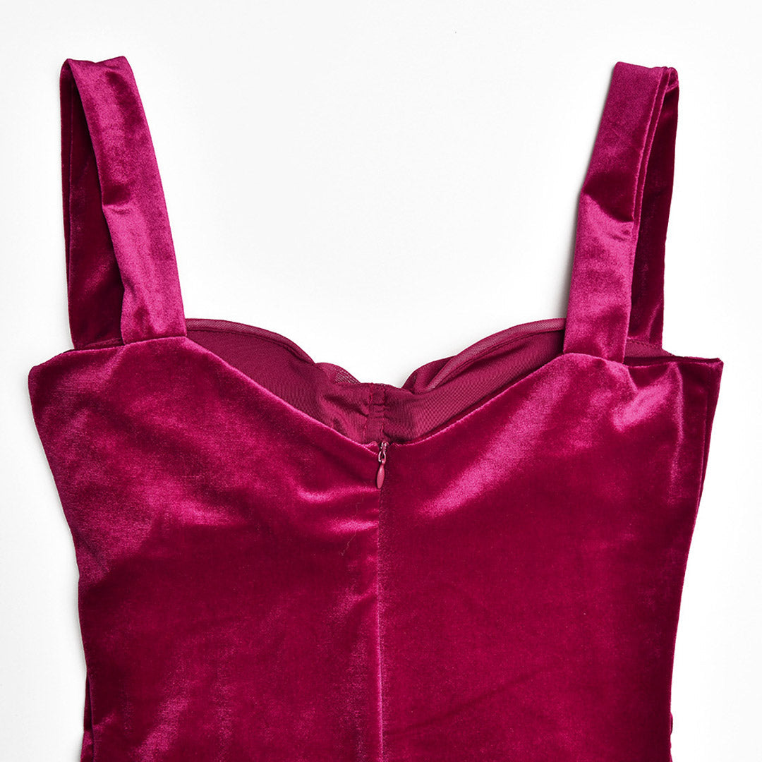 close-up of the bodice and zipper of a burgundy ruched velvet and mesh dress