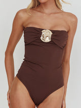 Brown strapless one-piece swimsuit with embellished hardware