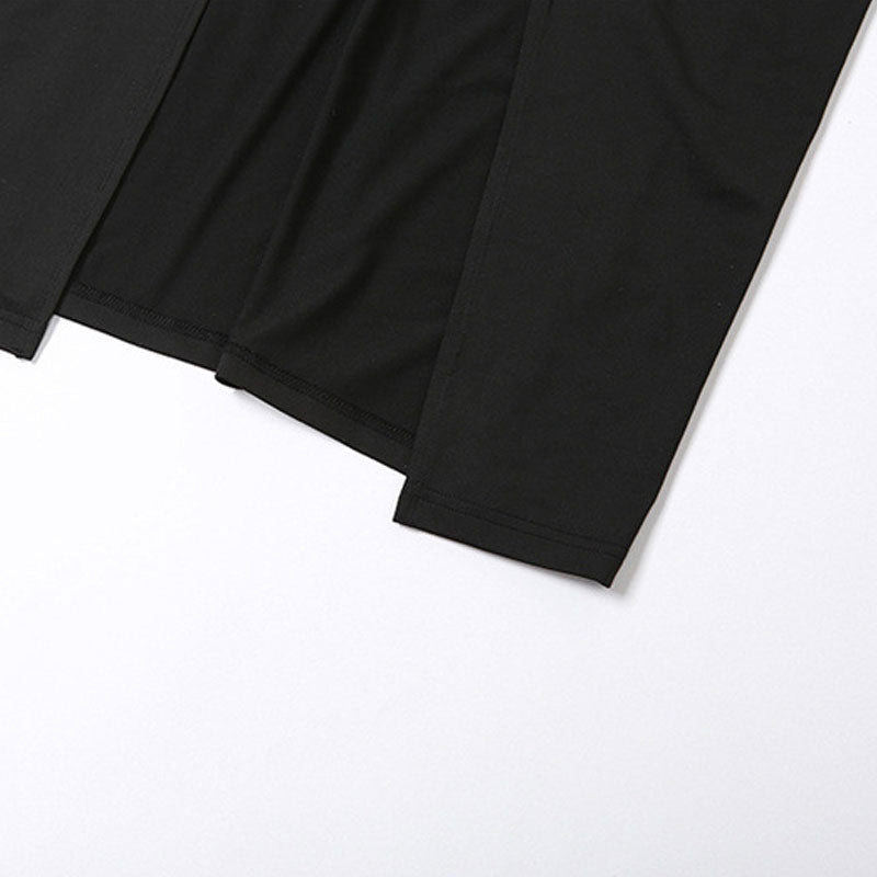 Close-up of the hem of a black maxi dress with a high slit