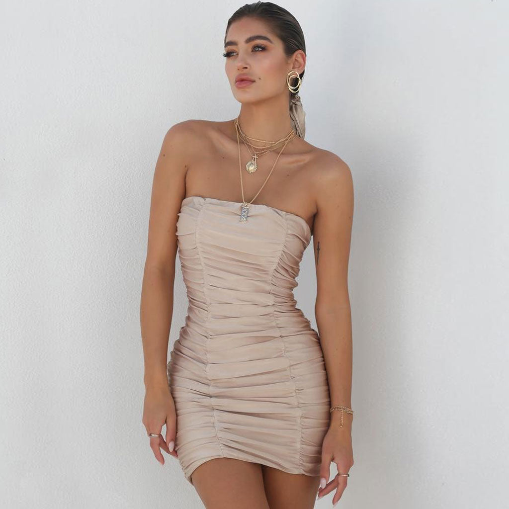 woman in a strapless ruched mini dress
