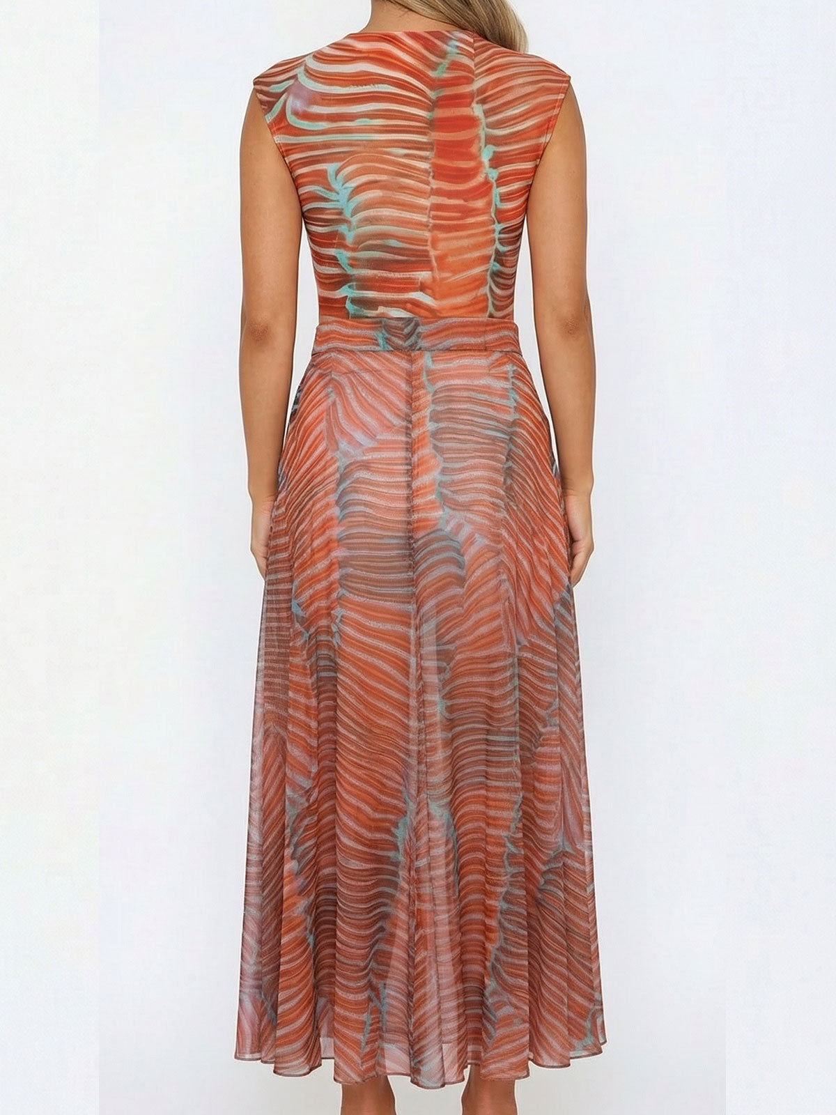 Back view of a woman wearing a sheer, orange and blue printed maxi dress.