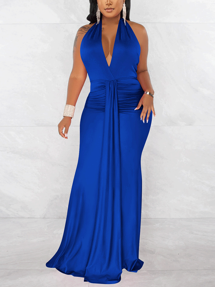 Woman wearing a long royal blue halter dress with a deep V-neckline and ruched waist