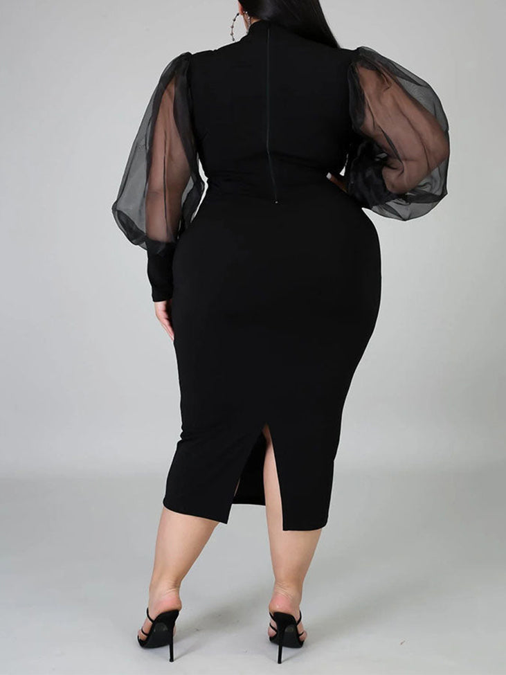 Plus-size woman wearing a black mock neck sheath dress with sheer puff sleeves and a slit hem, back view
