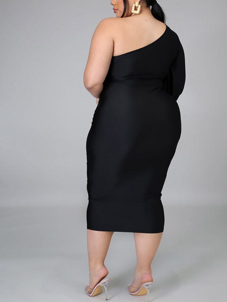 Flat lay of a black one-shoulder midi dress with a flared sleeve
