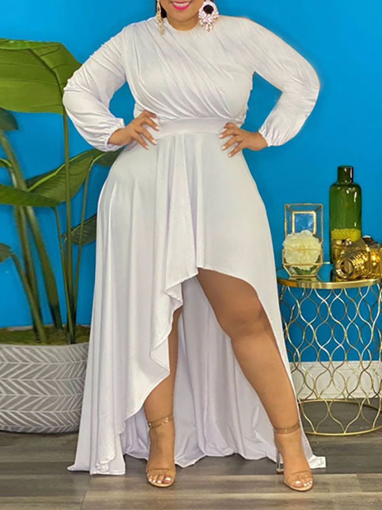 Woman wearing a white long-sleeved, high-low hemline dress with a ruched bodice.