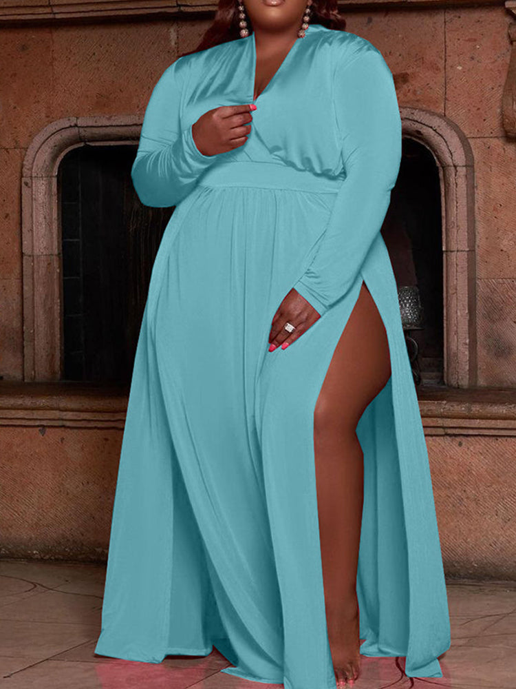 woman wearing a long teal maxi dress with a high slit and long sleeves