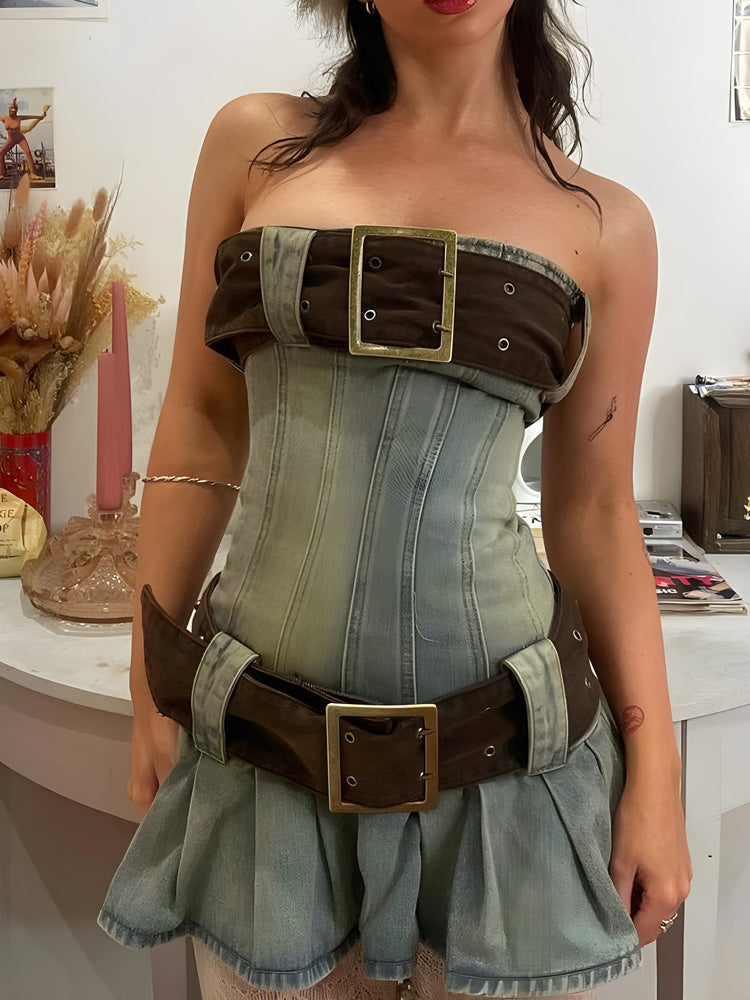 Full body shot of a strapless denim corset dress with brown belt details and a pleated skirt.