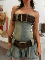 Full body shot of a strapless denim corset dress with brown belt details and a pleated skirt.