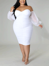 Woman wearing a white off-the-shoulder ruched midi dress with sheer puff sleeves.