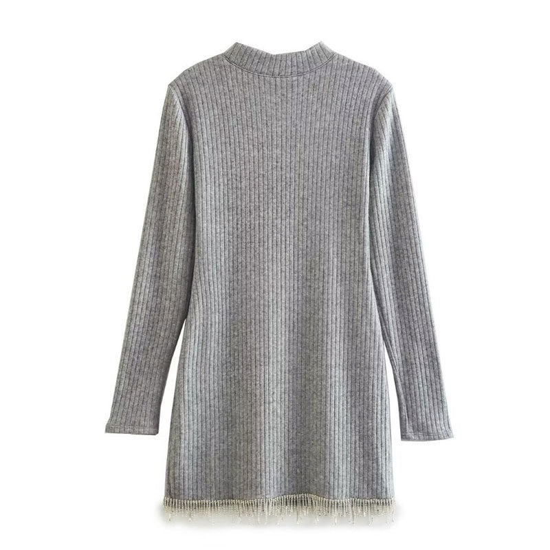 Back view of a grey ribbed knit mini dress with long sleeves and rhinestone trim hem.