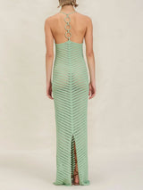 Back view of a woman wearing a mint green chevron knit maxi dress with an open back and ring detail