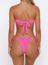 Close-up of the front of the pink bikini top with a bow detail