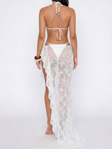 Rear view of a woman in a white bikini and lace sarong