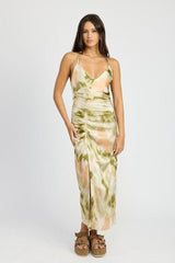woman posing in a tie-dye slip dress with a thigh-high slit