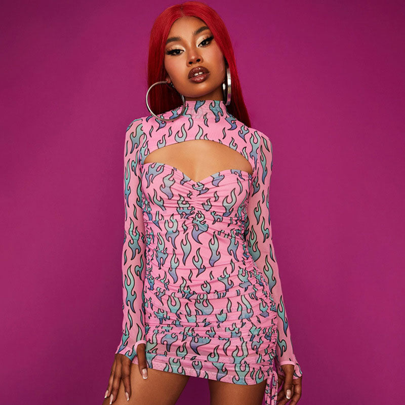 Woman wearing a pink long-sleeve dress with a flame print and cutout detail