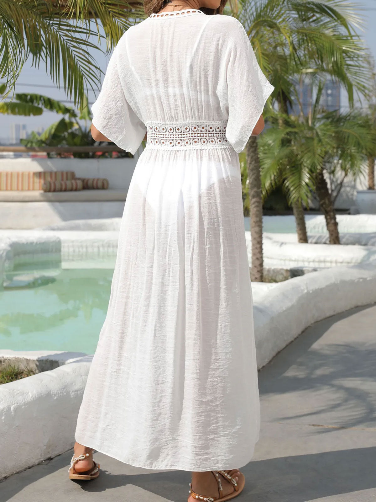 Back view of a woman wearing a white maxi cover-up