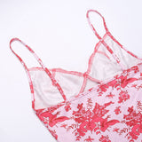 Detail of the spaghetti straps and lace trim on a pink floral print slip dress
